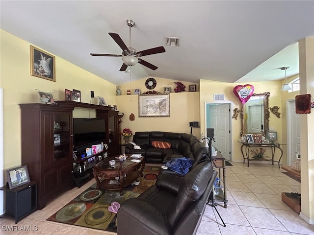 tiled living room with ceiling fan and vaulted ceiling