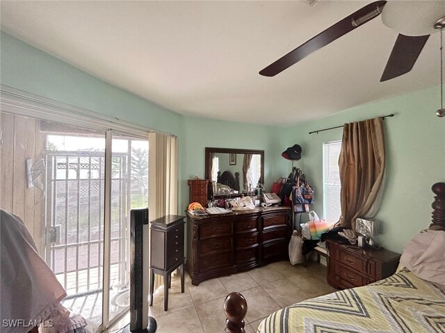 bedroom featuring light tile patterned flooring, access to exterior, and ceiling fan