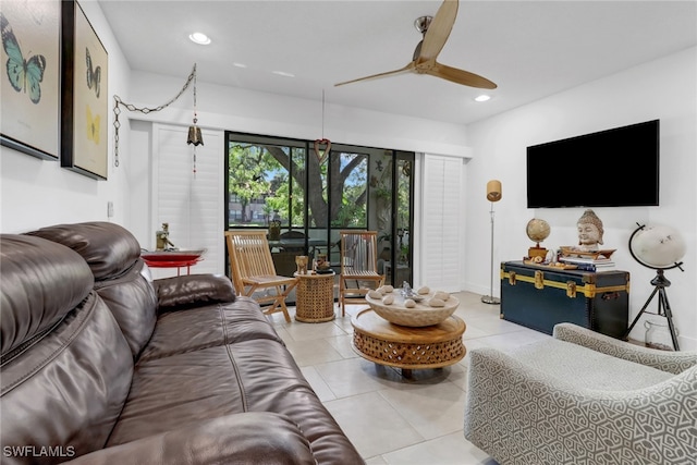 tiled living area with ceiling fan and recessed lighting