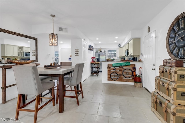 dining room with light tile patterned flooring, visible vents, and recessed lighting