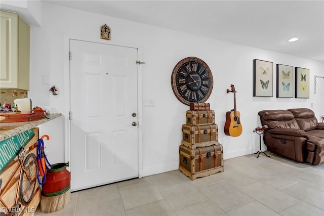 foyer entrance with light tile patterned floors