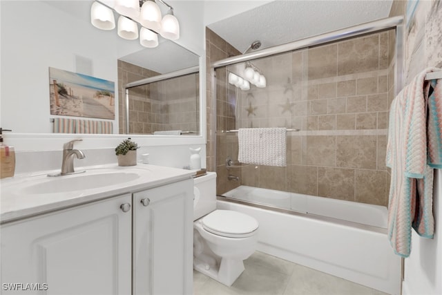 full bathroom featuring combined bath / shower with glass door, vanity, toilet, and tile patterned floors