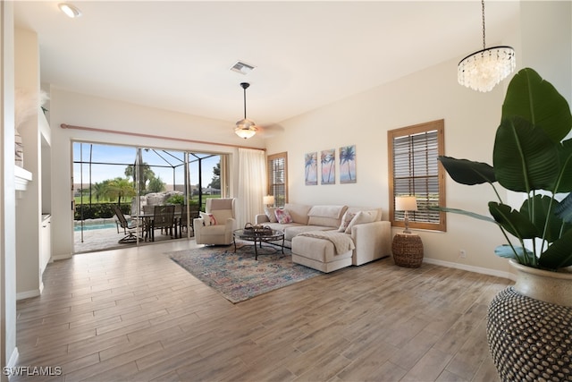 living room featuring light hardwood / wood-style floors and an inviting chandelier