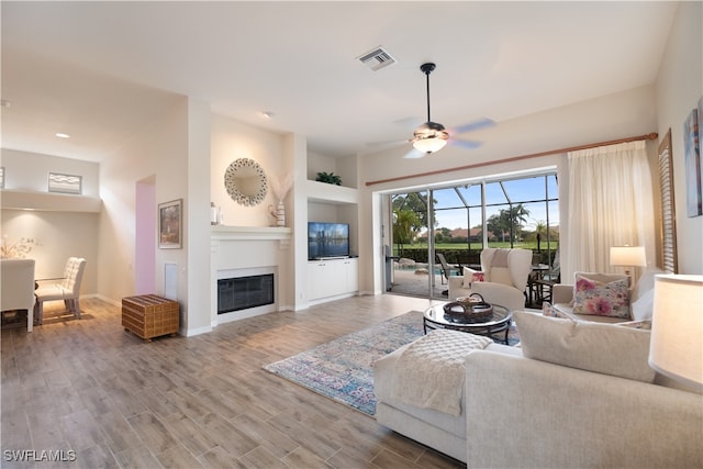 living room featuring ceiling fan and wood-type flooring