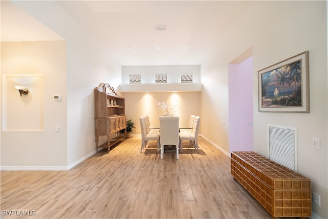 dining space with light hardwood / wood-style floors