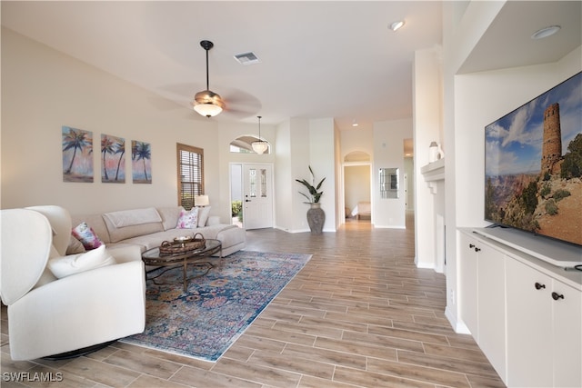 living room with ceiling fan and light hardwood / wood-style floors