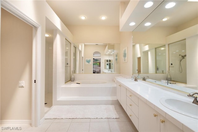 bathroom featuring tile patterned floors, vanity, and shower with separate bathtub