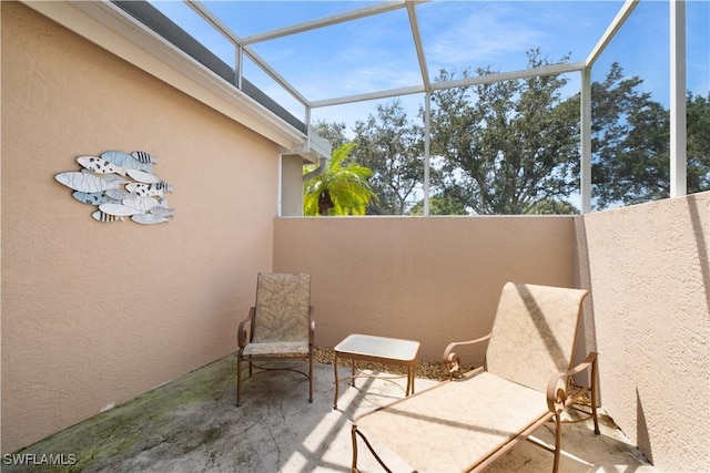 view of patio with glass enclosure