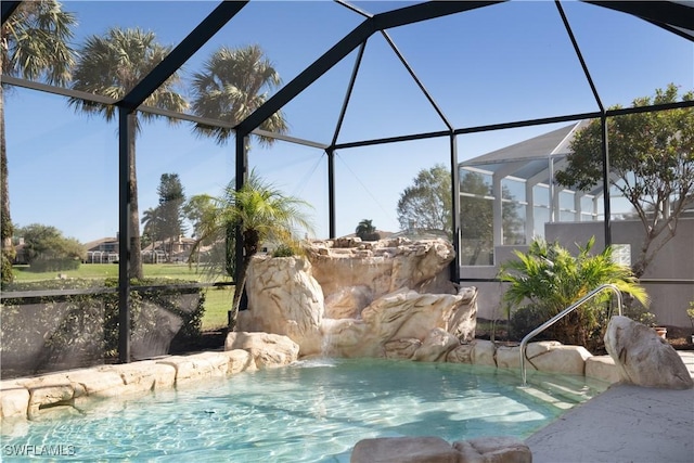 view of swimming pool featuring pool water feature and a lanai