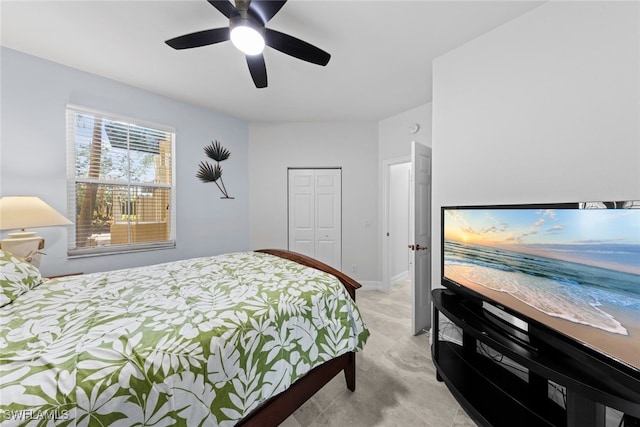 bedroom with ceiling fan, a closet, and light carpet