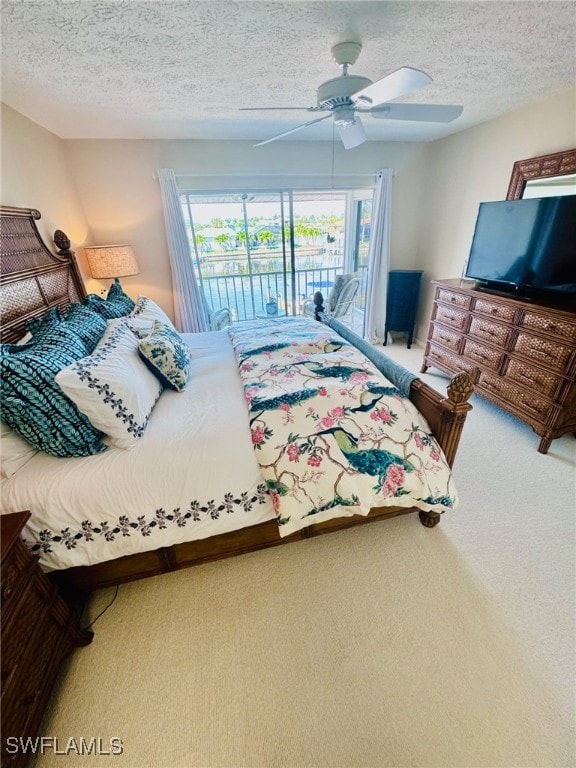 carpeted bedroom with multiple windows, ceiling fan, access to outside, and a textured ceiling