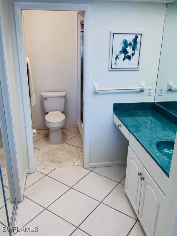 bathroom with vanity, toilet, and tile patterned flooring