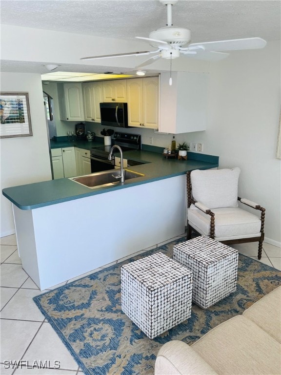 kitchen featuring electric stove, a textured ceiling, light tile patterned floors, kitchen peninsula, and ceiling fan