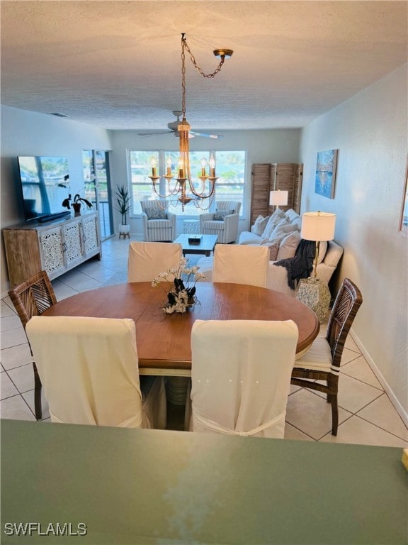 tiled dining area featuring ceiling fan and a textured ceiling