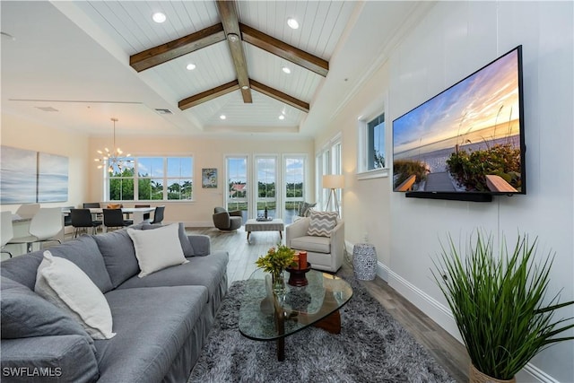 living room featuring lofted ceiling with beams, hardwood / wood-style floors, and a chandelier