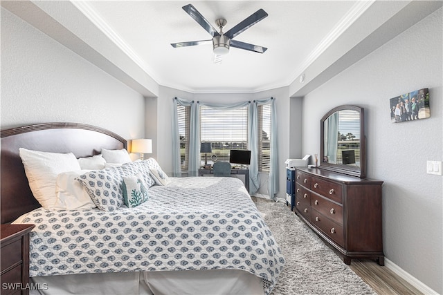 bedroom with ceiling fan, crown molding, and light hardwood / wood-style flooring