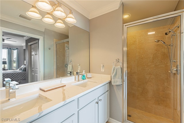 bathroom featuring crown molding, vanity, a chandelier, and a shower with door