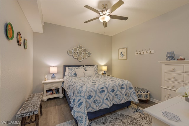 bedroom featuring ceiling fan and dark hardwood / wood-style floors