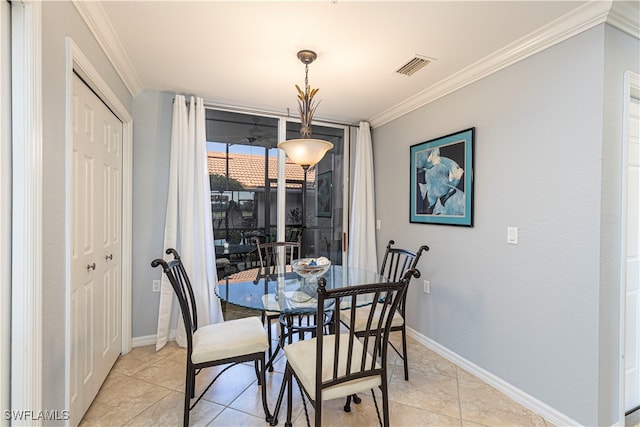 tiled dining space featuring ornamental molding