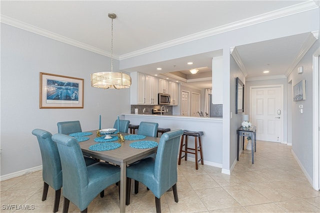 dining space with ornamental molding, light tile patterned floors, and sink