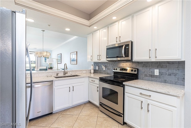 kitchen featuring light tile patterned floors, appliances with stainless steel finishes, white cabinetry, sink, and ornamental molding