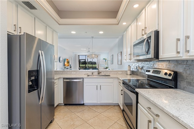 kitchen with ornamental molding, light tile patterned floors, stainless steel appliances, sink, and white cabinets