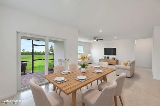 tiled dining room featuring ceiling fan