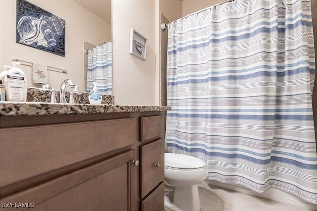 bathroom featuring walk in shower, toilet, and vanity