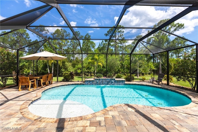 view of swimming pool with glass enclosure, pool water feature, and a patio area