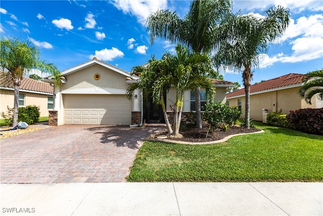 view of front of home with a garage and a front lawn