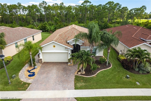 mediterranean / spanish home featuring a front lawn