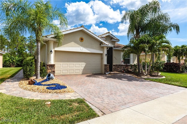 view of front of home featuring a garage and a front lawn