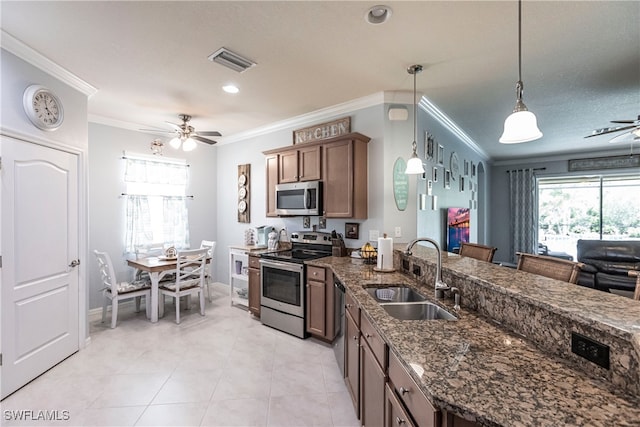 kitchen with hanging light fixtures, ceiling fan, sink, and appliances with stainless steel finishes