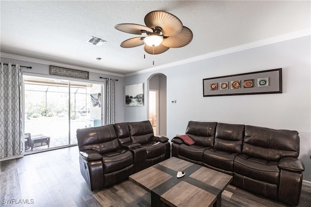 living room with ornamental molding, dark hardwood / wood-style flooring, ceiling fan, and a textured ceiling