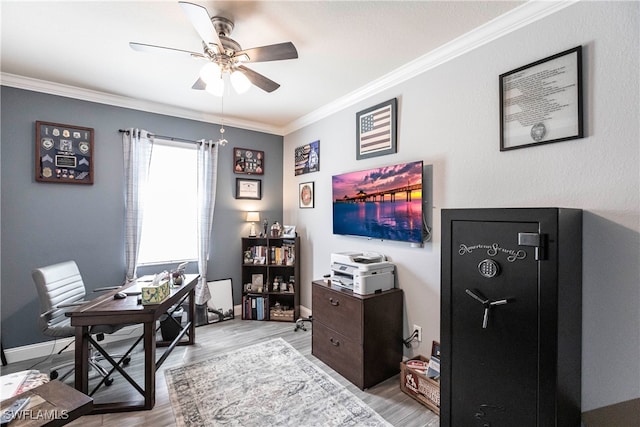 office space featuring ceiling fan, light hardwood / wood-style floors, and crown molding