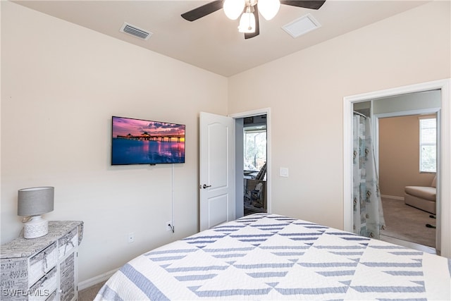 carpeted bedroom featuring ceiling fan and multiple windows