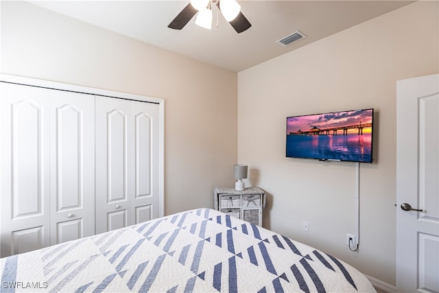 bedroom with ceiling fan and a closet