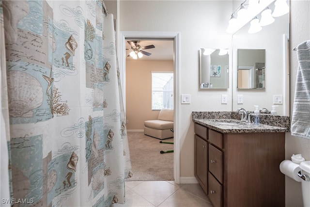 bathroom featuring tile patterned flooring, vanity, ceiling fan, and walk in shower