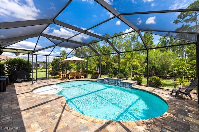 view of swimming pool with pool water feature, a lanai, and a patio