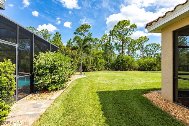 view of yard featuring glass enclosure