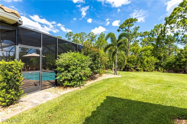 view of yard featuring glass enclosure