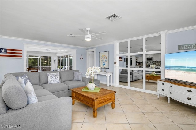 living room with light tile patterned floors, crown molding, and ceiling fan