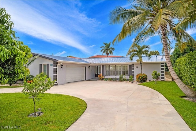 ranch-style home with a garage and a front lawn