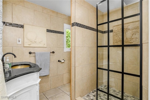 bathroom with vanity and a tile shower