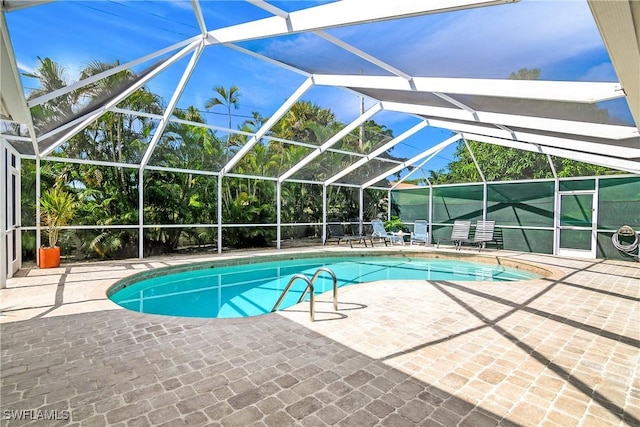 view of pool with a lanai and a patio area