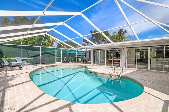 view of swimming pool with a lanai and a patio area