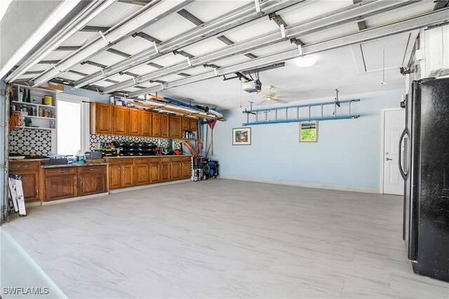 garage with black refrigerator and a garage door opener