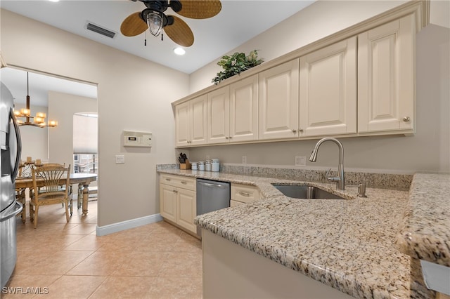 kitchen featuring decorative light fixtures, ceiling fan with notable chandelier, light stone counters, sink, and light tile patterned flooring