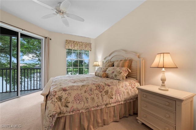 bedroom featuring light carpet, multiple windows, access to exterior, and ceiling fan