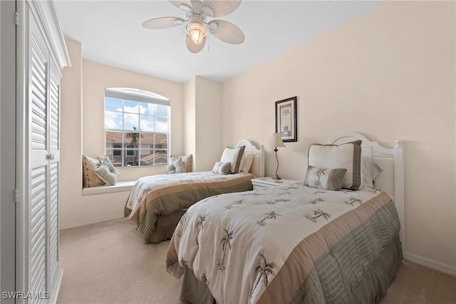 bedroom with ceiling fan and light carpet